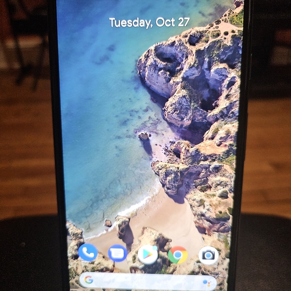 Sleek Black Smartphone with Coastal Display